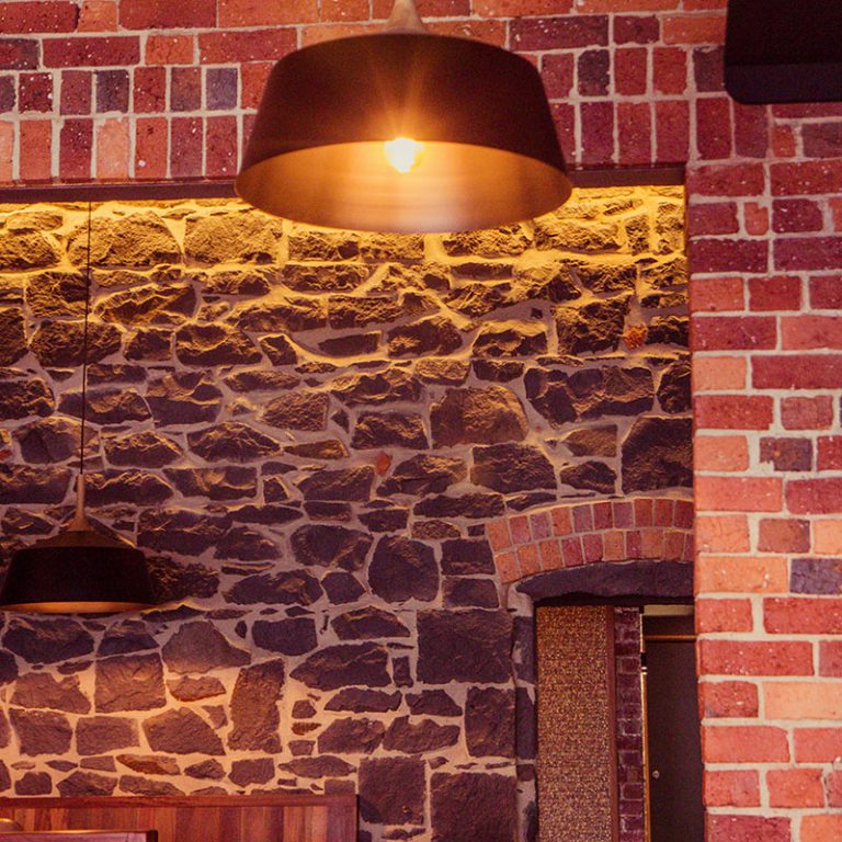 A bluestone and brick detailed wall in a bar