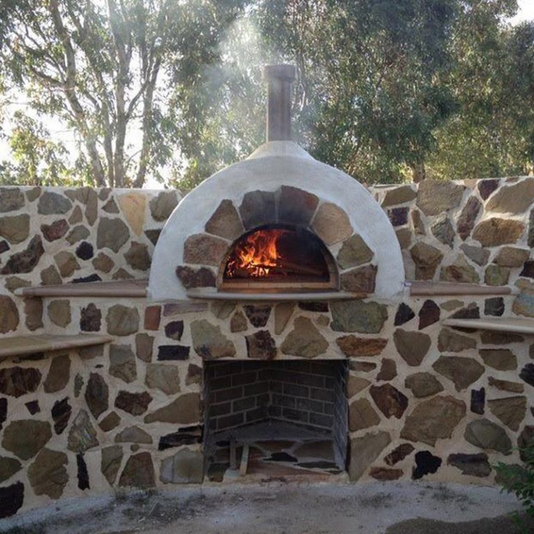 A custom stone pizza oven with surrounding walls