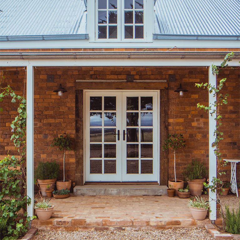 A brick house with double french doors