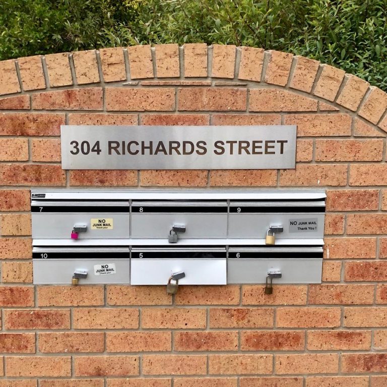 A brick wall for apartment letterboxes